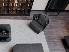 View from above of a sitting room with Twist armchair and Oasi cupboard in a pleasant combination of dark tones