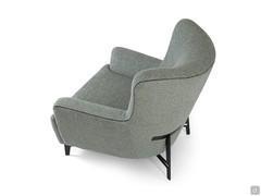 The Doyle armchair with soft forms, embellished by a Grosgrain ribbon