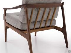 Back view of the armchair Amaya with elegant exposed solid walnut wood frame