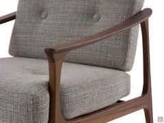 Detail of the Amaya armchair with handcrafted solid wood armrest and Cocò 26 fabric upholstery