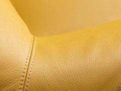 Detail of the stitching of the Agata Lounge leather upholstered armchair