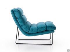 Side view showing the generous feather-mix padding of the cushions and the sinuous shape of the frame with solid wood core