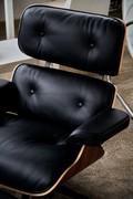 The Eames armchair, a replica inspired by Charles Eames’ design, is available in wood, leather or fabric