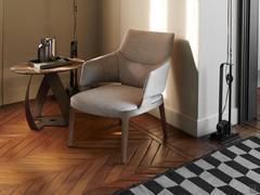 Velis solid wood leg armchair in the high-back version, accompanied by the Bon Bon coffee table