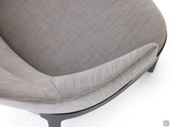 Detail of the upholstered shell that forms the back and armrests into a single curved volume