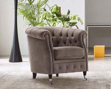 Isadora armchair in a chesterfield style with fixed back feet and frontal feet on casters