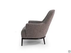 Side-view of the René armchair with reclined backrest