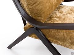 Detail of the curved wooden frame of the armchair Jody that forms the feet, armrest and back upright