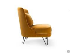 Side view of the Beatrix armchair with a comfortable lumbar cushion