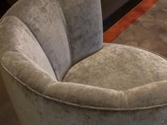 Detail of the upholstered shell-shaped backrest of the Petra armchair