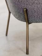 Detail of the metal tubular legs in brushed bronze finish