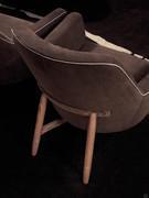 Close-up of the Lynn  armchair with hand-turned wooden base