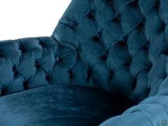 Detail of Elina velvet upholstery on plain seat and armrests and capitonné backrest