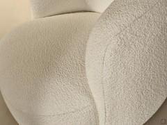 Detail of the bouclé fabric upholstery that finds its ultimate expression in Aralia and its curved shapes