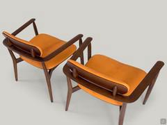 Couple of Victoria armchairs. The back view highlights how the armrest and backrest is part of a single wooden structure.