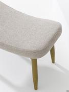 Sophos modern pouf with four stained beech legs and upholstered saddle seat