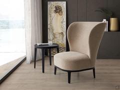 The Spring armchair, upholstered in the fabric beige Cruise Chenille