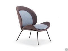 Sleek armchair with high metal feet in brushed bronze or lacquered metal