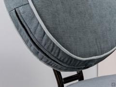 Detail of the completely removable and machine washable backrest covering of the Alice armchair