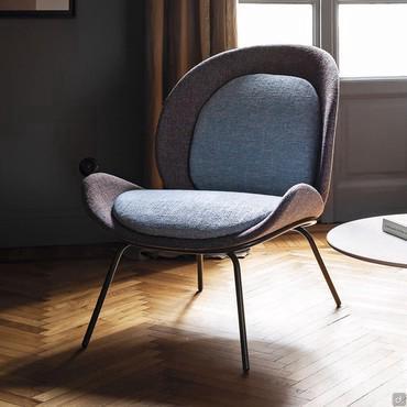 Athena minimalist armchair with high slim metal legs