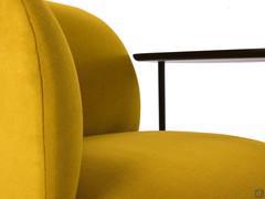 Detail of the upholstered volumes and rounded profiles of the Fortune armchair