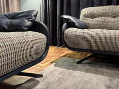 Detail of the curved rigid structure that accommodates the soft cushions, a contrasting effect emphasised by the two-tone leather and fabric upholstery