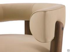 Detail of the wooden structure set into the upholstered volumes and fixed with a decorative stud