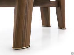 Detail of the wooden legs ending in brass-finished metal spikes