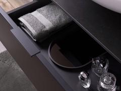 The first drawer of the basin base unit is shaped to provide maximum space despite the presence of the siphon