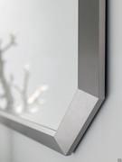 Detail of the shaped mirror of the N94 Atlantic bathroom cabinet, with brushed aluminum frame