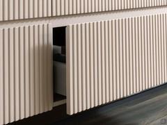 Close-up of the slatted MDF fronts with a 45° cut of the top edge. Notice the smooth horizontal trim edge in matching colour