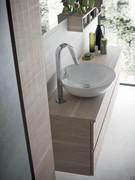 Washbasin base unit with off-centre mixer (not included). On various washbasins the positioning of the mixer hole can be customised, with a choice of wall or top hole.