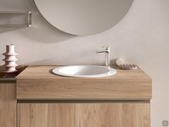 Front view of the Atlantic Incasso bathroom cabinet p.62 cm. The 12.5 cm thick top in melamine to match the base, the full-width metal profile opening and the round Spazio washbasin in glossy white ceramic stand out