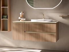 Bathroom cabinet with built-in Atlantic washbasin in wood-effect veneer 279 Cinnamon, door and drawer opening via full-width Palladium-painted metal profile