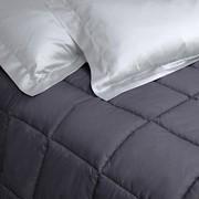 Detail of Natura cotton quilt graphite color and pearl gray color satin pillowcases