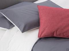 Detail of duvet cover set with bag and pillowcases in two colours