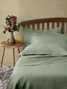 Bed set in pure Dill Green Linen, here proposed with pillowcases with ruffles, but also available with pillowcases with sack