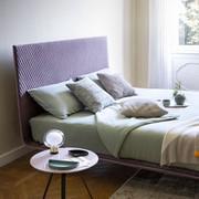 Thin bed by Bonaldo with smooth headboard