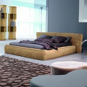 Fluff is a soft, down-padded bed by Bonaldo with painted wood feet