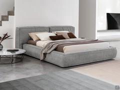 Upholstered bed in soft feather Fluff by Bonaldo, with storage box and imbotitto bed frame to match the headboard