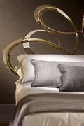 Detail of the swirling precious headboard, whose delicate volume has been obtained by cold bending and laser cut