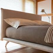 Renoir is a minimal design upholstered bed with curved feet and upholstered slim bed frame. Detail of the headboard without cushions.