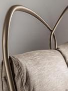 Detail of the manually welded and polished solid tapered iron headboard