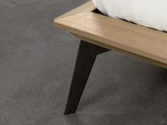 Detail of Moka Shine metal leg mounted on thin wooden bed frame