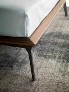 Detail of the high feet painted in Moka Shine. Bed-frame finish is thermo baked oak wood veneer