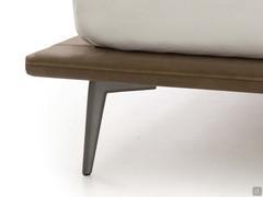 Detail of the high burnished metal foot matched with the slim bed frame in Tivano leather