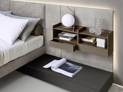 California upholstered bed with wall panelling matched with shelves with drawers