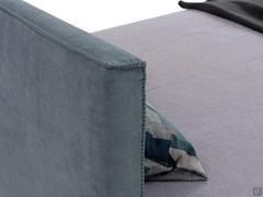 Detail of the square-profile headboard finished with horse stitching (closed embroidery)