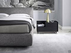 Detail of high upholstered bed frame with storage box