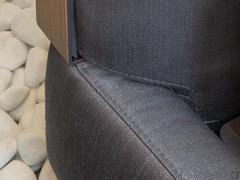 Detail of the stitching and seam between the upholstered bed frame and headboard